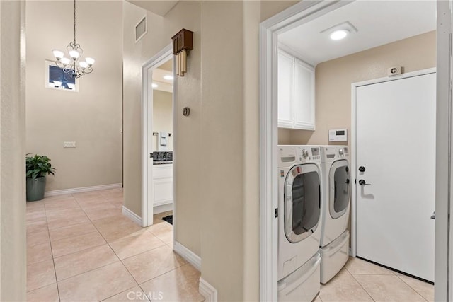 530 S Laureltree Dr, Anaheim Hills, CA 92808 - laundry area with washing machine and dryer, cabinet space, light tile patterned floors, and a chandelier