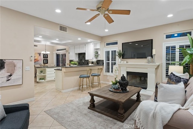 530 S Laureltree Dr, Anaheim Hills, CA 92808 - living area with light tile patterned floors, ceiling fan, a glass covered fireplace, recessed lighting, and a chandelier