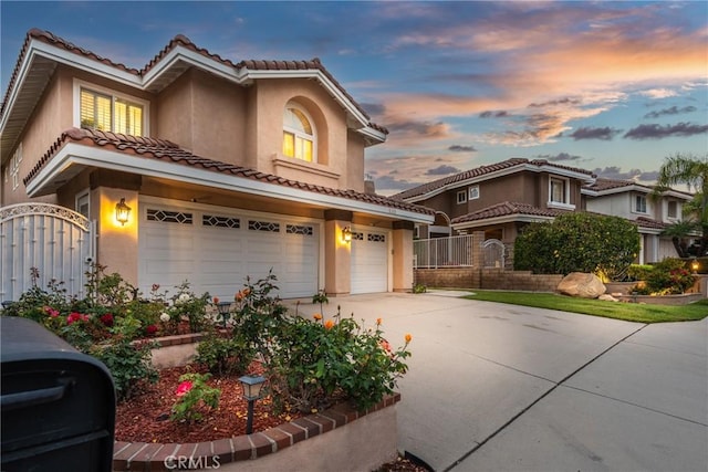 530 S Laureltree Dr, Anaheim Hills, CA 92808 - mediterranean / spanish house featuring a tiled roof, stucco siding, a garage, a gate, and concrete driveway