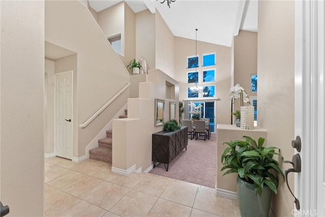 530 S Laureltree Dr, Anaheim Hills, CA 92808 - carpeted foyer entrance with tile patterned flooring, stairs, high vaulted ceiling, and a chandelier