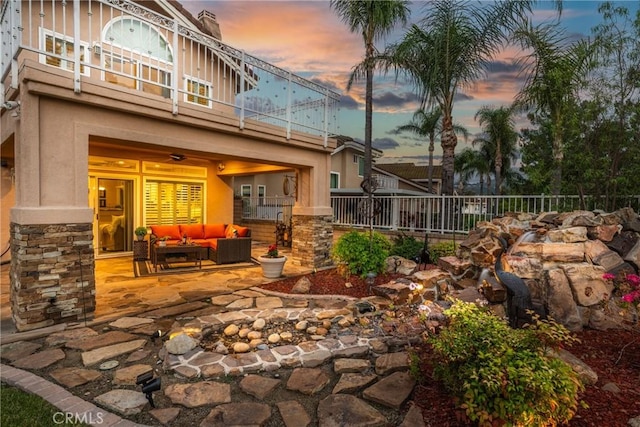 530 S Laureltree Dr, Anaheim Hills, CA 92808 - patio terrace at dusk featuring a balcony, outdoor lounge area, and a patio area