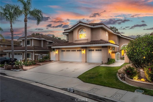 530 S Laureltree Dr, Anaheim Hills, CA 92808 - mediterranean / spanish-style home with a tiled roof, stucco siding, an attached garage, concrete driveway, and a yard