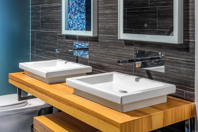 3879 Ocean Front Walk, San Diego, CA 92109 - bathroom featuring decorative backsplash, tile walls, toilet, and a sink