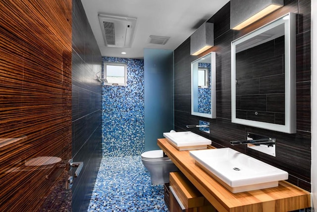 3879 Ocean Front Walk, San Diego, CA 92109 - bathroom featuring tile walls, toilet, tiled shower, and vanity