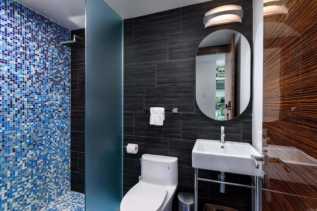 3879 Ocean Front Walk, San Diego, CA 92109 - bathroom with tile walls, tiled shower, toilet, and a sink