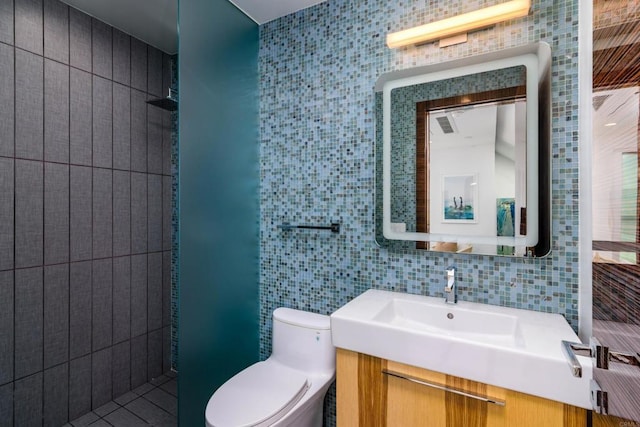 3879 Ocean Front Walk, San Diego, CA 92109 - bathroom with tile walls, toilet, vanity, and tasteful backsplash