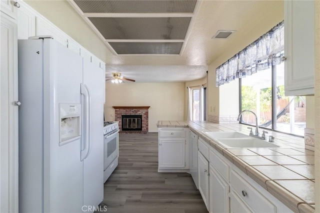 1573 E Brockton Ave, Redlands, CA 92374 - kitchen featuring white appliances, a sink, tile counters, a ceiling fan, and ventilation hood
