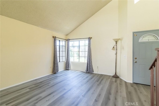 1573 E Brockton Ave, Redlands, CA 92374 - foyer featuring high vaulted ceiling, wood finished floors, and baseboards