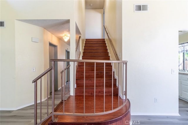 1573 E Brockton Ave, Redlands, CA 92374 - staircase with wood finished floors and baseboards