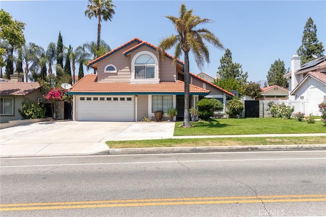 1573 E Brockton Ave, Redlands, CA 92374 - view of front facade featuring a tile roof, an attached garage, and driveway