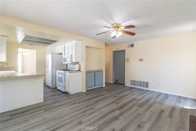 1573 E Brockton Ave, Redlands, CA 92374 - kitchen featuring white appliances, tile countertops, a ceiling fan, light wood-type flooring, and a textured ceiling