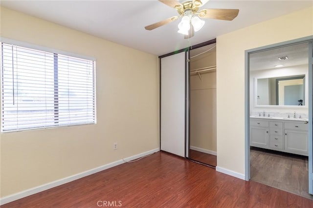 1573 E Brockton Ave, Redlands, CA 92374 - unfurnished bedroom featuring dark wood-style flooring, baseboards, a closet, a sink, and a ceiling fan