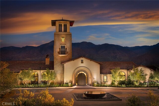 11638 Oakton Way, Corona, CA 92883 - view of front facade featuring a mountain view, a chimney, curved driveway, and stucco siding