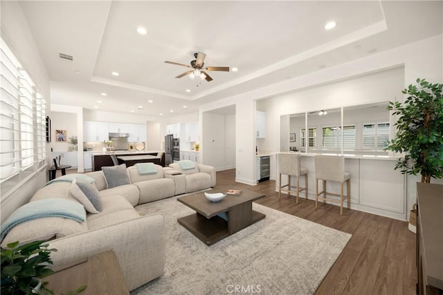 11638 Oakton Way, Corona, CA 92883 - living room with a tray ceiling, ceiling fan, wine cooler, wood finished floors, and recessed lighting