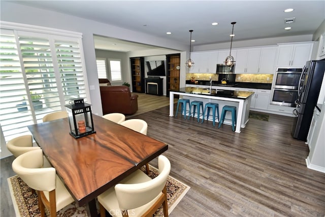 35582 Laurel Tree Ct, Winchester, CA 92596 - dining space with dark wood-style flooring and recessed lighting