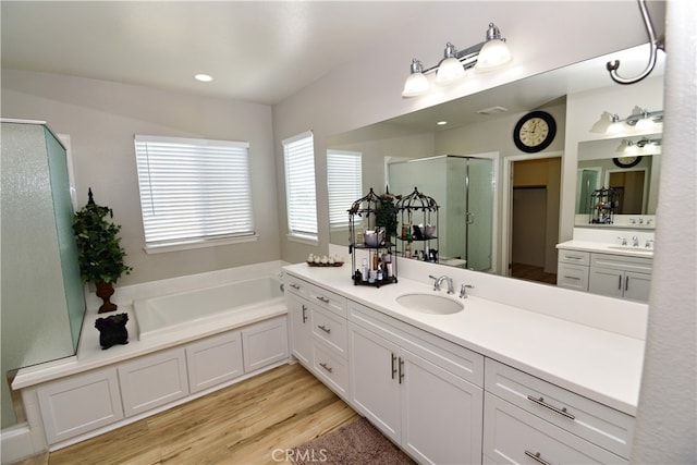 35582 Laurel Tree Ct, Winchester, CA 92596 - full bath with a shower stall, vanity, wood finished floors, and a garden tub