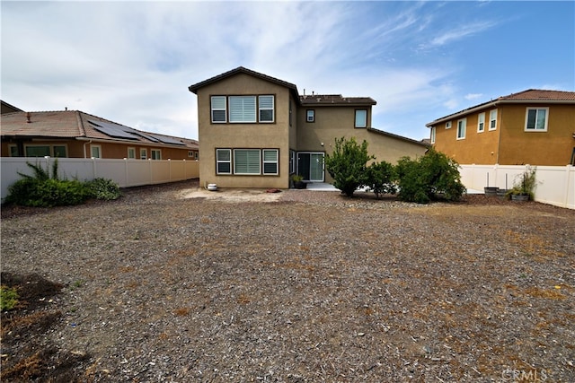 35582 Laurel Tree Ct, Winchester, CA 92596 - rear view of house with a fenced backyard and stucco siding