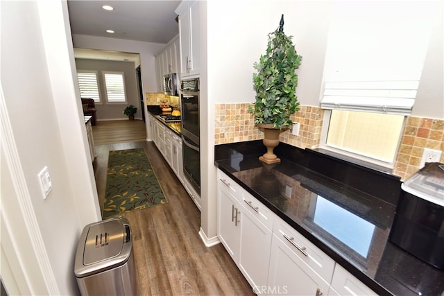 35582 Laurel Tree Ct, Winchester, CA 92596 - kitchen with dark wood-style flooring, stainless steel appliances, white cabinetry, and recessed lighting