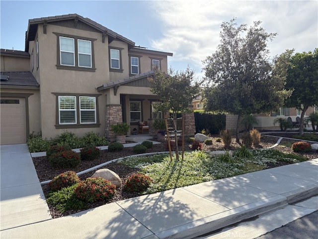 35582 Laurel Tree Ct, Winchester, CA 92596 - view of front facade featuring stucco siding, stone siding, a porch, and a garage