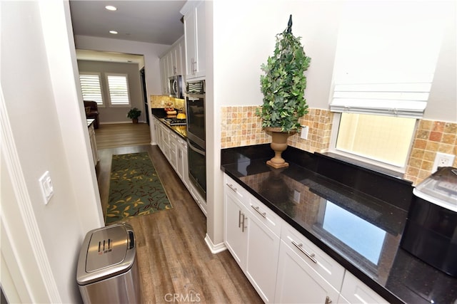 35582 Laurel Tree Ct, Winchester, CA 92596 - kitchen with dark wood finished floors, stainless steel appliances, white cabinetry, backsplash, and recessed lighting