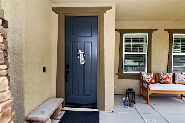 35582 Laurel Tree Ct, Winchester, CA 92596 - doorway to property featuring stucco siding and covered porch