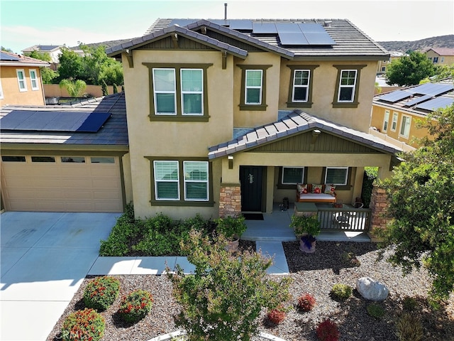 35582 Laurel Tree Ct, Winchester, CA 92596 - view of front of house with a porch, stucco siding, solar panels, a garage, and concrete driveway