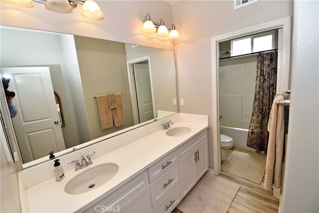 35582 Laurel Tree Ct, Winchester, CA 92596 - bathroom featuring double vanity, wood finished floors, and shower / tub combo with curtain