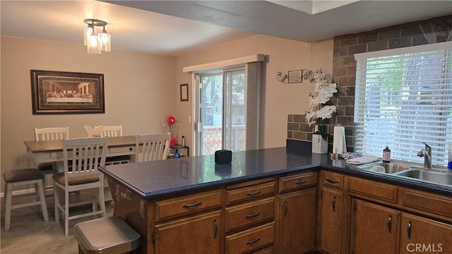 6286 Columbine Rd, Magalia, CA 95954 - kitchen featuring a sink, a peninsula, and brown cabinets