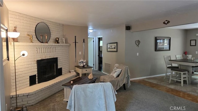 6286 Columbine Rd, Magalia, CA 95954 - living room with a brick fireplace, baseboards, and carpet floors
