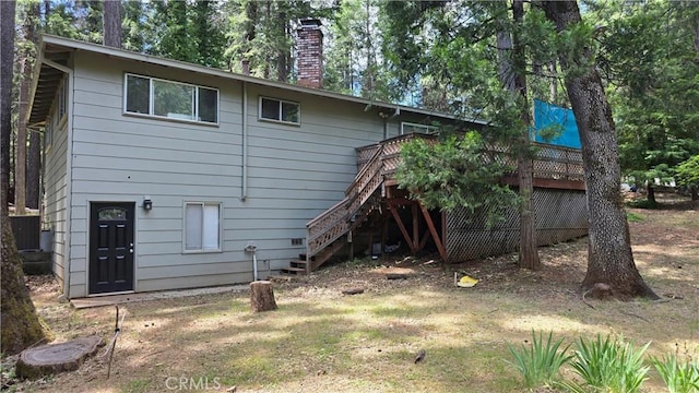 6286 Columbine Rd, Magalia, CA 95954 - back of property with stairs, a chimney, a wooden deck, and view of wooded area