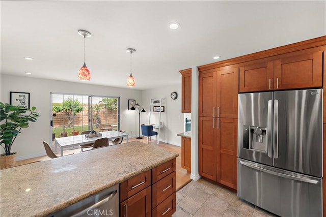 7455 Bellingham Ave, North Hollywood, CA 91605 - kitchen with stainless steel fridge, hanging light fixtures, recessed lighting, light stone countertops, and brown cabinetry
