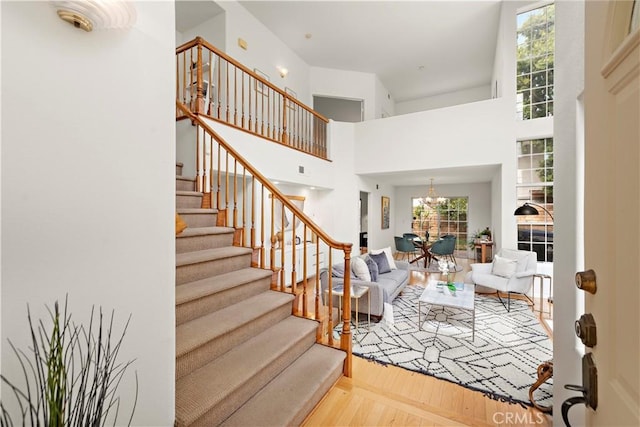 7455 Bellingham Ave, North Hollywood, CA 91605 - stairway with plenty of natural light, wood finished floors, a chandelier, and a high ceiling