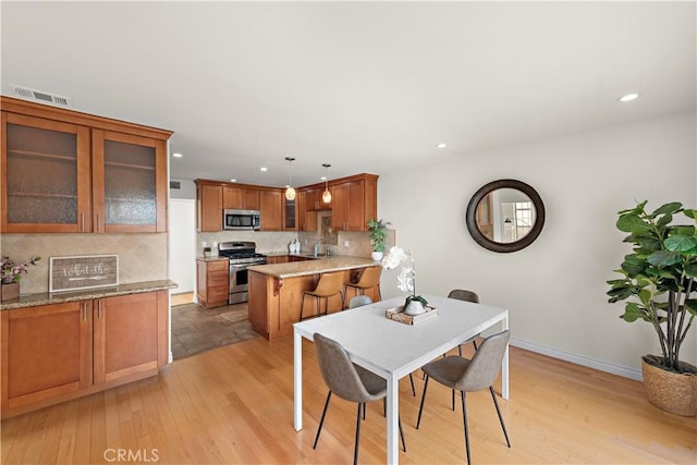7455 Bellingham Ave, North Hollywood, CA 91605 - dining room featuring recessed lighting, light wood-style flooring, and baseboards