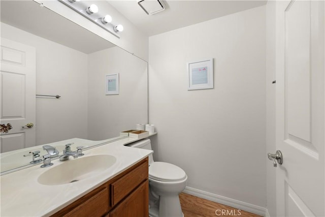 7455 Bellingham Ave, North Hollywood, CA 91605 - bathroom featuring vanity, toilet, baseboards, and wood finished floors