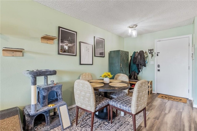 5585 E Pacific Coast Unit 361, Long Beach, CA 90804 - dining room with wood finished floors and a textured ceiling