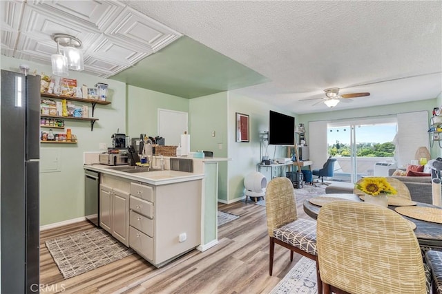 5585 E Pacific Coast Unit 361, Long Beach, CA 90804 - kitchen featuring freestanding refrigerator, light wood-style floors, open floor plan, dishwasher, and a peninsula