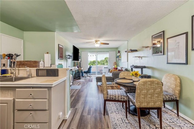 5585 E Pacific Coast Unit 361, Long Beach, CA 90804 - dining space featuring ceiling fan, wood finished floors, and a textured ceiling