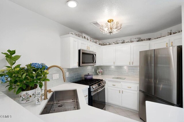 2911 Butter Creek Dr, Pasadena, CA 91107 - kitchen with stainless steel appliances, light countertops, a chandelier, and tasteful backsplash
