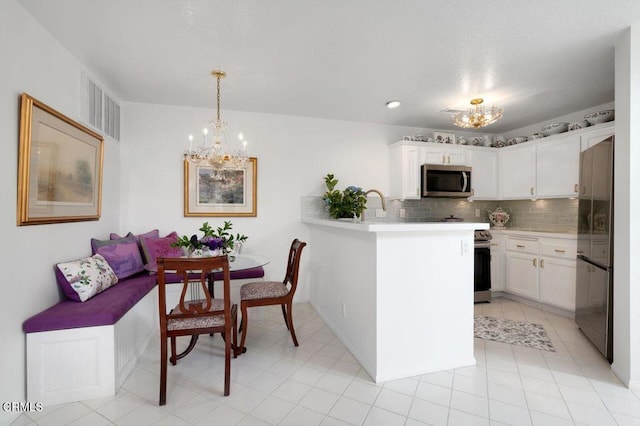 2911 Butter Creek Dr, Pasadena, CA 91107 - kitchen with a chandelier, appliances with stainless steel finishes, light countertops, a peninsula, and white cabinetry