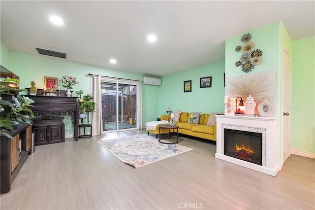 1257 E Grand Ave Unit A, Escondido, CA 92027 - living area with an AC wall unit, wood finished floors, recessed lighting, a premium fireplace, and baseboards