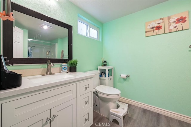 1257 E Grand Ave Unit A, Escondido, CA 92027 - bathroom featuring toilet, a shower stall, wood finished floors, vanity, and baseboards