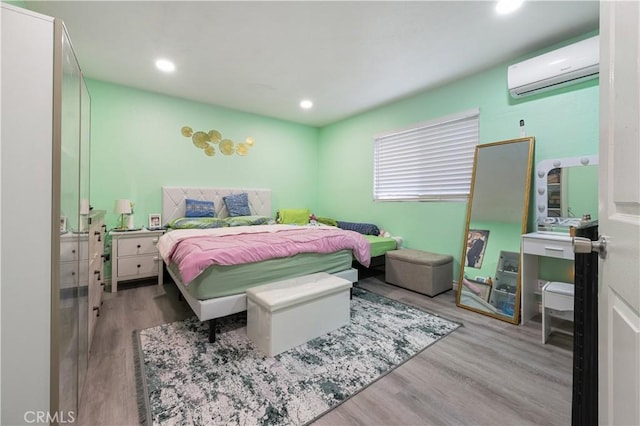 1257 E Grand Ave Unit A, Escondido, CA 92027 - bedroom featuring a wall mounted AC, wood finished floors, and recessed lighting