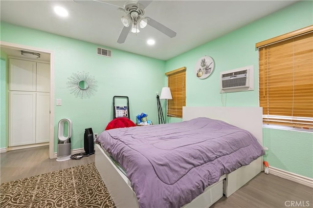 1257 E Grand Ave Unit A, Escondido, CA 92027 - bedroom featuring a wall unit AC, wood finished floors, baseboards, recessed lighting, and a ceiling fan