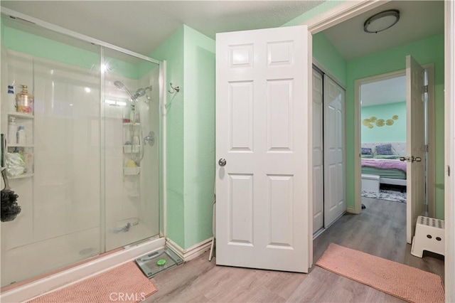 1257 E Grand Ave Unit A, Escondido, CA 92027 - full bathroom with a stall shower, wood finished floors, ensuite bath, and baseboard heating
