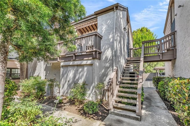 26701 Quail Unit 61, Laguna Hills, CA 92656 - back of property featuring stucco siding, stairs, and a balcony