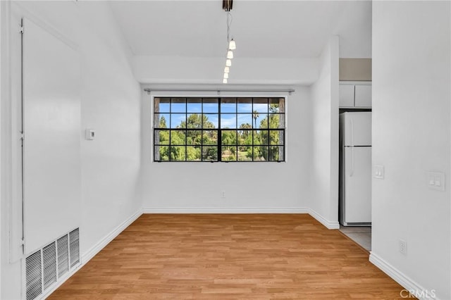26701 Quail Unit 61, Laguna Hills, CA 92656 - unfurnished dining area with light wood-style flooring and baseboards