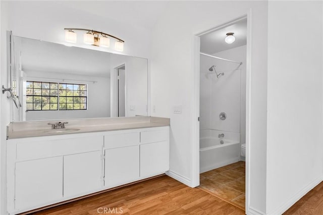 26701 Quail Unit 61, Laguna Hills, CA 92656 - bathroom featuring tub / shower combination, vanity, toilet, and wood finished floors