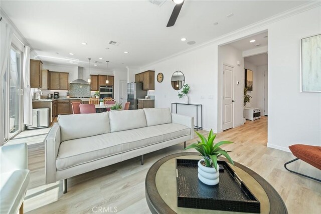843 Longhorn Way, Rancho Mission Viejo, CA 92694 - living area with light wood-style floors, crown molding, a ceiling fan, recessed lighting, and baseboards