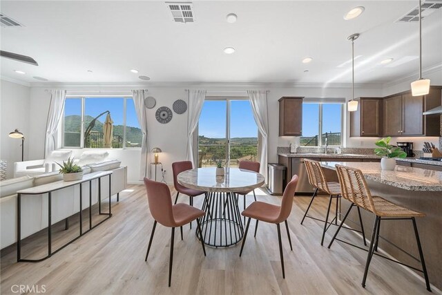 843 Longhorn Way, Rancho Mission Viejo, CA 92694 - dining room with crown molding, light wood-style floors, recessed lighting, and baseboards