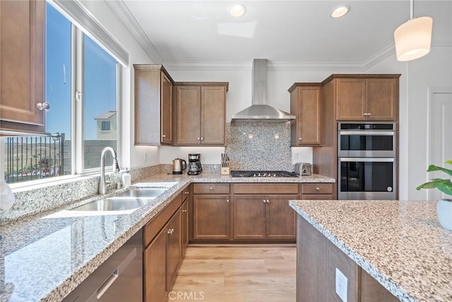 843 Longhorn Way, Rancho Mission Viejo, CA 92694 - kitchen featuring wall chimney range hood, a sink, stainless steel appliances, light wood finished floors, and light stone counters
